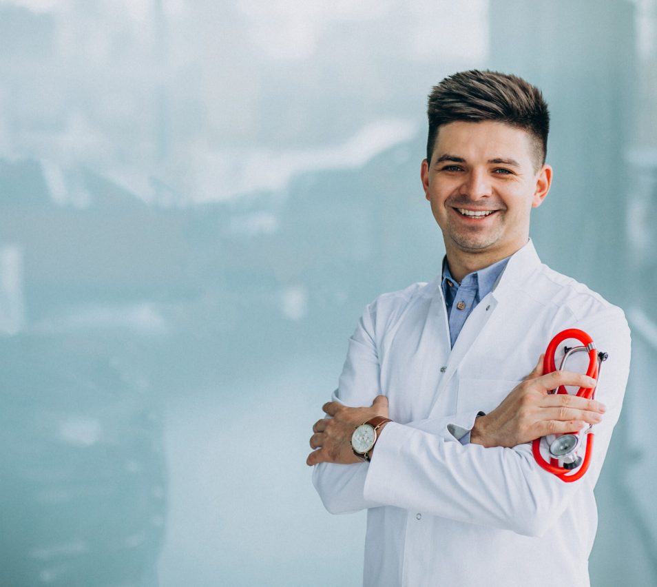 Young handsome physician in a medical robe with stethoscope